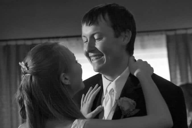 bride and groom dancing in black and white