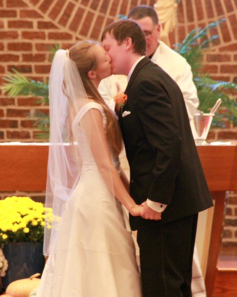 bride and groom first kiss