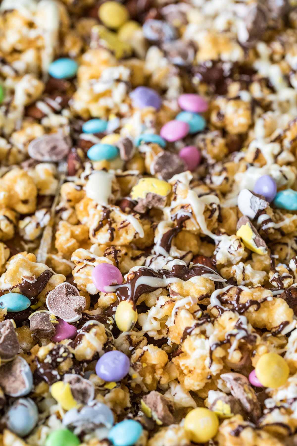 tray full of chocolate drizzled bunny munch with pastel candy