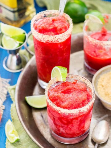 Strawberry margarita granita with a slice of lime, on a silver serving tray