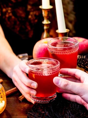 Glass of red liquid being handed off