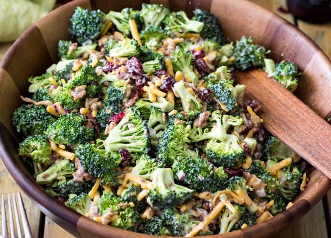 An easy and delicious BROCCOLI SALAD with bacon! This recipe is always a hit! Easy to make and packed with flavor! #summerfood #broccolisalad #salad #potluck Large serving bowl of broccoli salad
