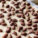 Chocolate coated almonds on parchment paper