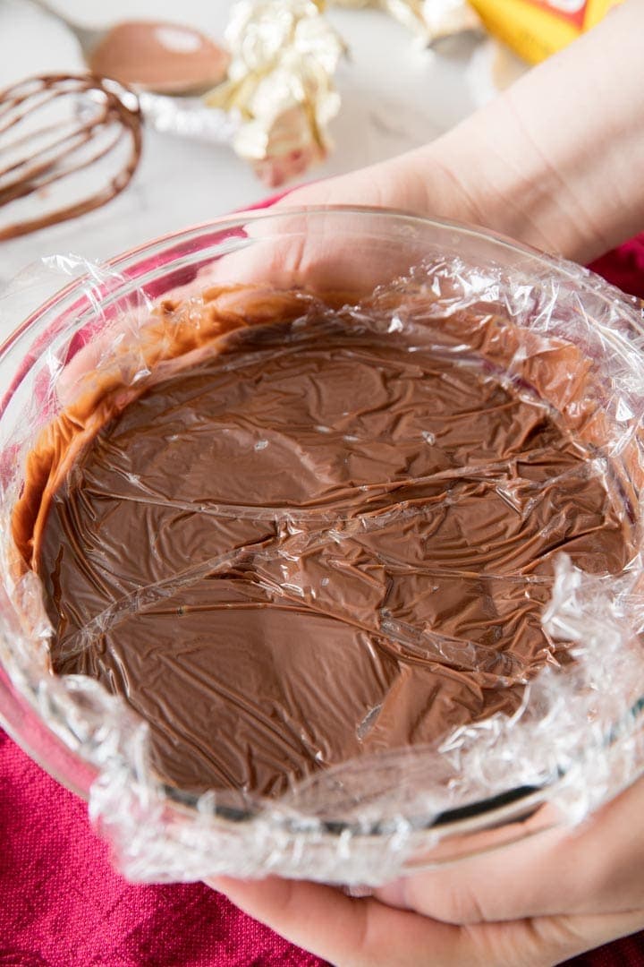 Laying clear wrap over the surface of your homemade chocolate pudding is a good, easy way to keep a skin from forming Cling wrap over the surface of homemade pudding