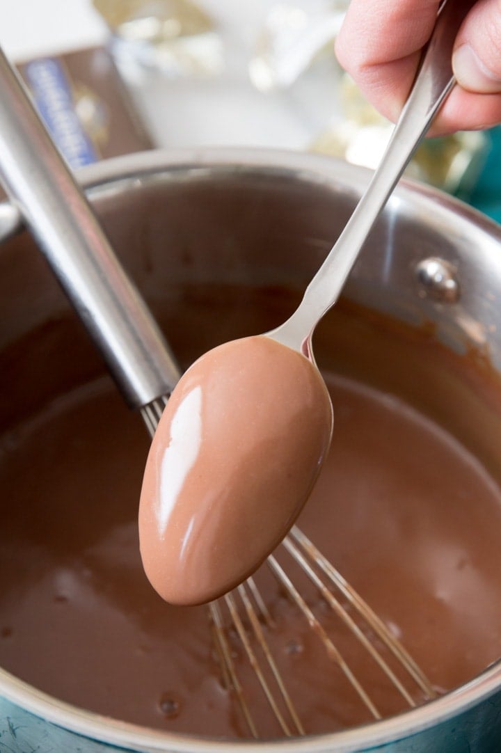 When your pudding mixture coats the back of a spoon, it has thickened enough to remove from heat Chocolate pudding mixture coating the back of a spoon to show that it's done thickening