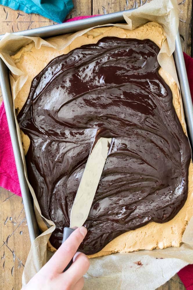 Spreading Chocolate Ganache over Peanut butter Shortbread Bars