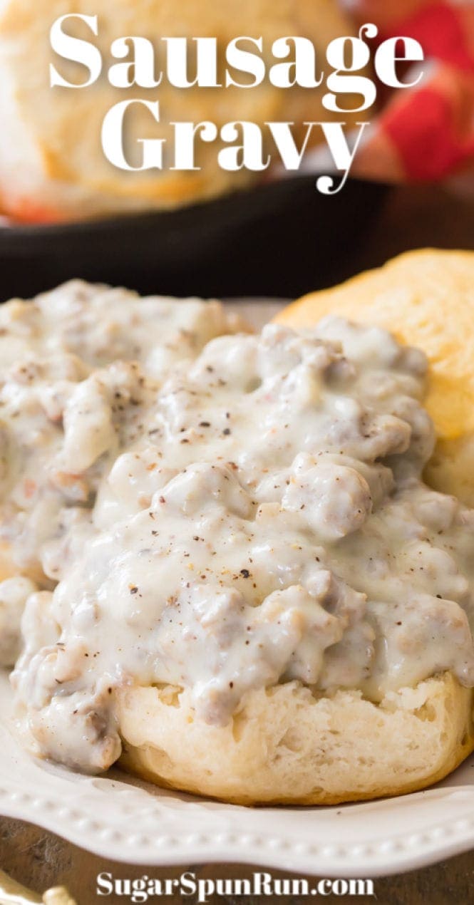 Sausage gravy on biscuits on white plate