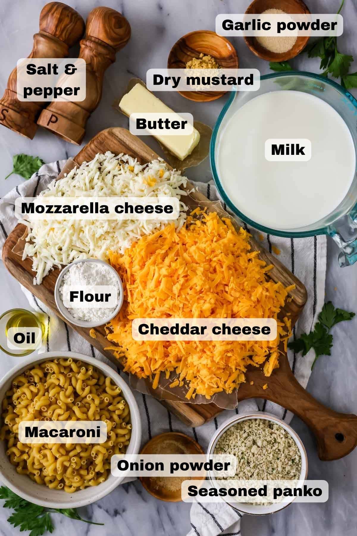 The creamiest, easiest Baked Mac and Cheese Recipe! This is so good! #macandcheese #dinnerrecipe #kidfriendlyrecipe Overhead, labeled view of ingredients needed for baked macaroni and cheese.