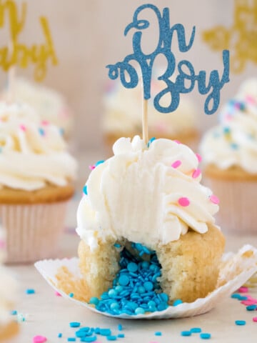 Cupcake broken open to reveal insides topped with frosting and "oh Boy!" decoration