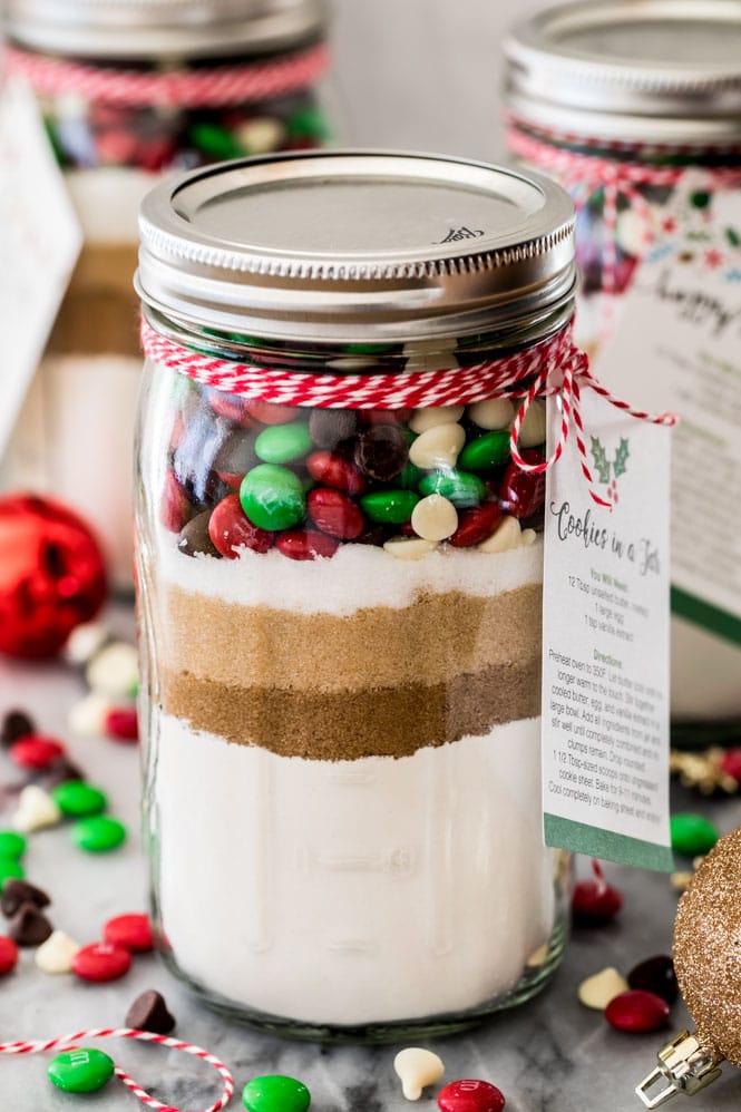 Jar of cookie mix showing layered ingredients and gift tag