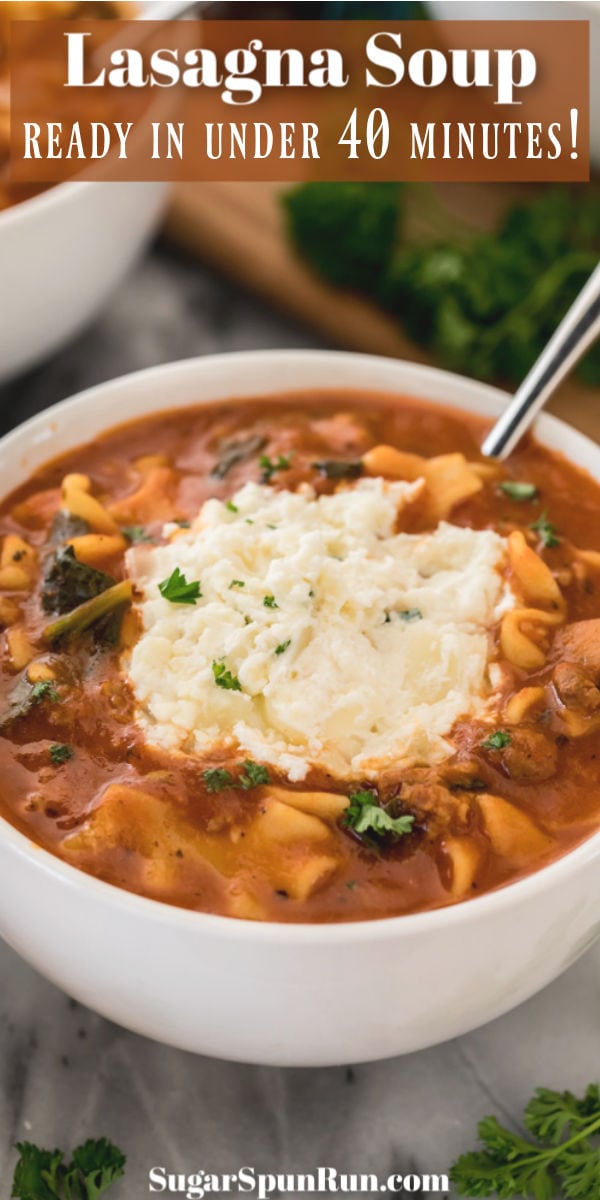 Lasagna soup topped with ricotta cheese mixture in white bowl