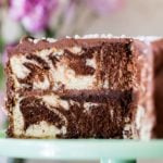 Marble cake on cake platter with slice taken out