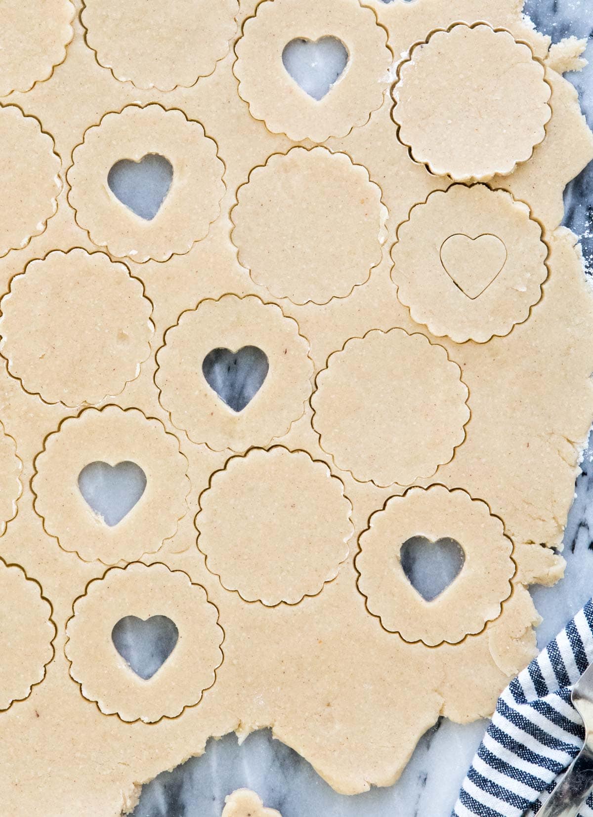 cookie dough with round and heart cutouts
