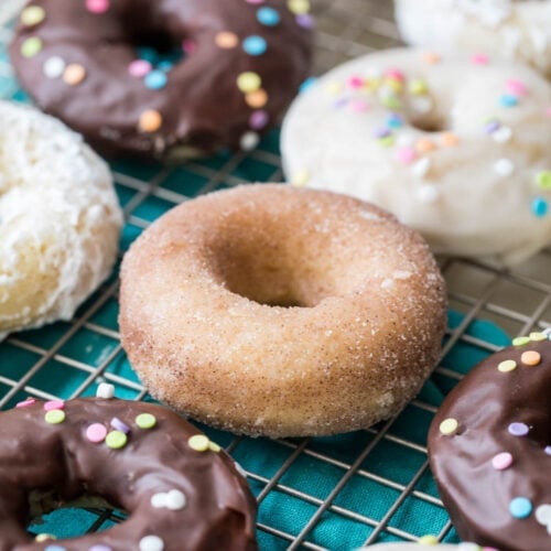 baked donuts with different toppings (chocolate frosting, cinnamon sugar, white frosting)