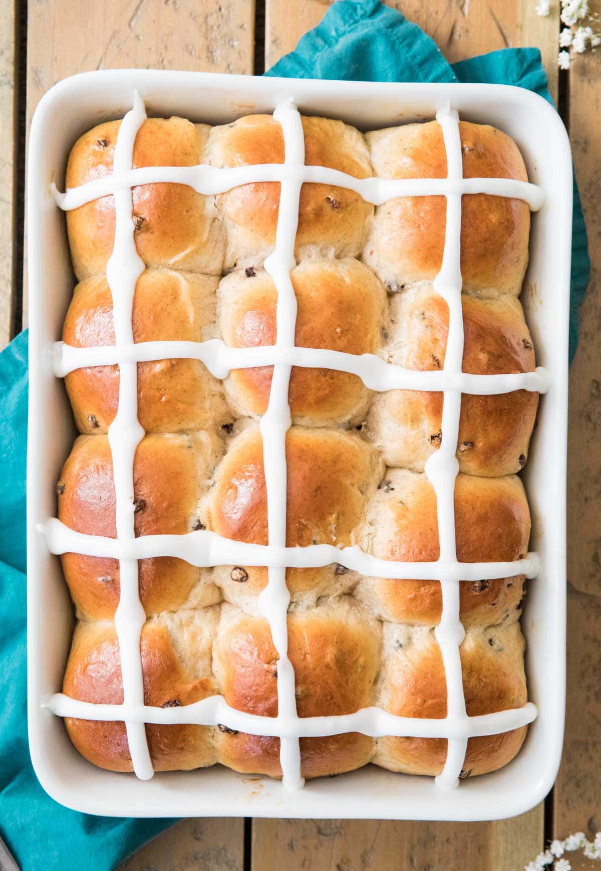 Iced buns in a white baking dish.