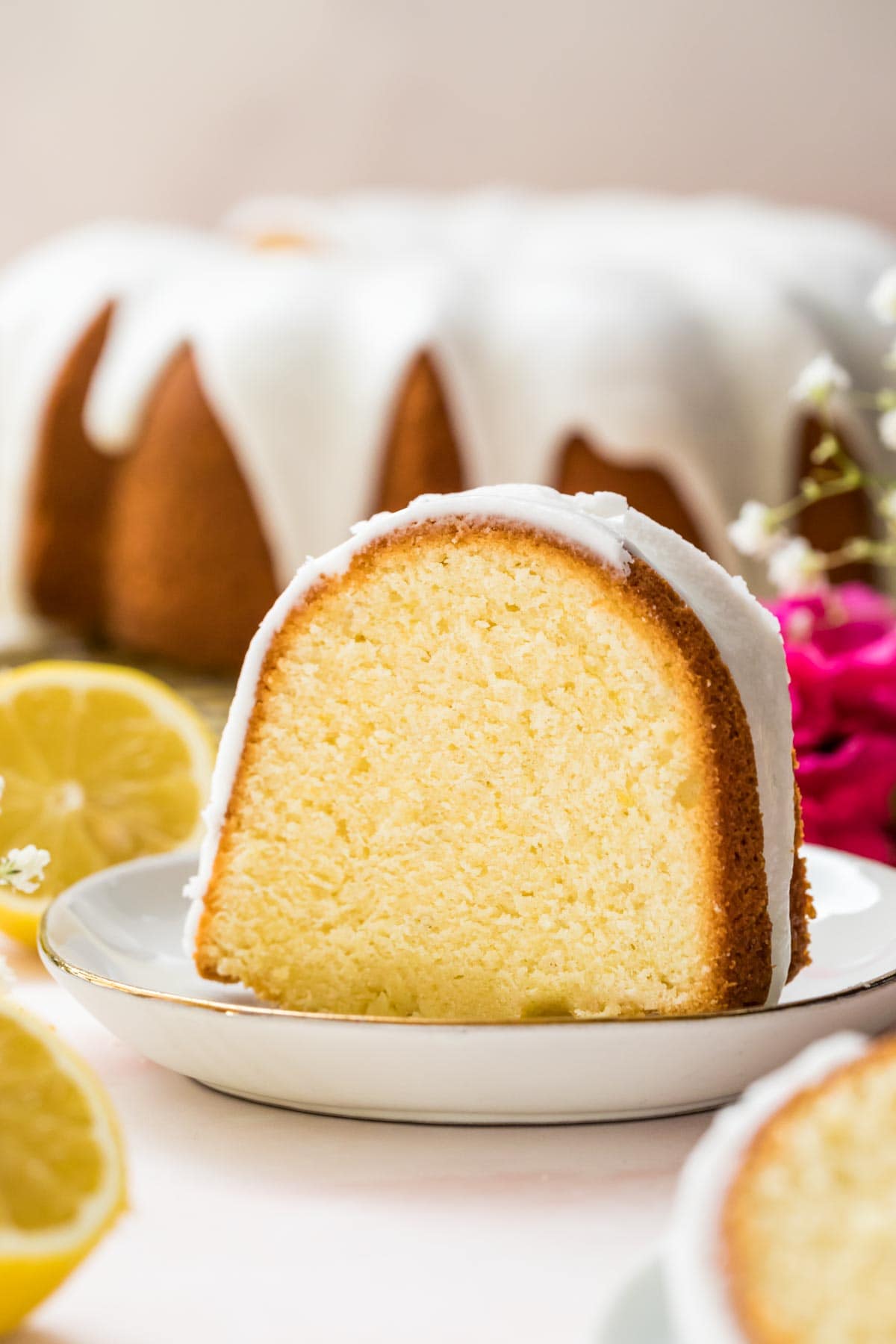 Lemon pound cake slice on a white plate.