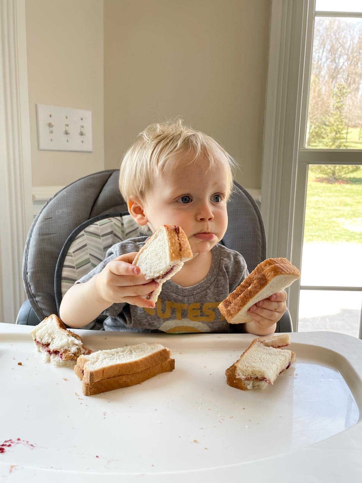 toddler eating peanut butter and jelly