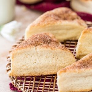 Cinnamon sugar dusted snickerdoodle scones on gold cooling rack