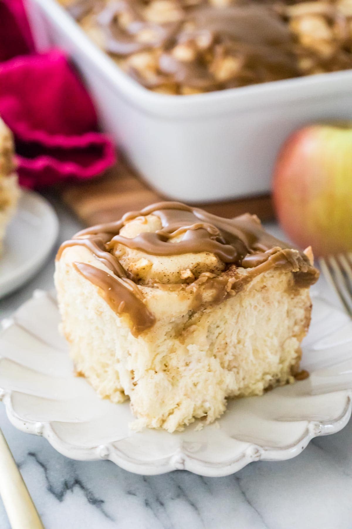 close-up view of apple cinnamon roll on white plate