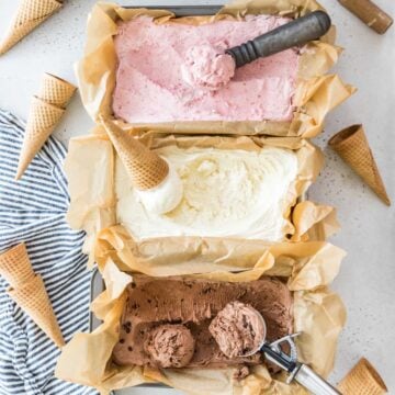 overhead view of three flavors of no churn ice cream including strawberry, vanilla, and chocolate