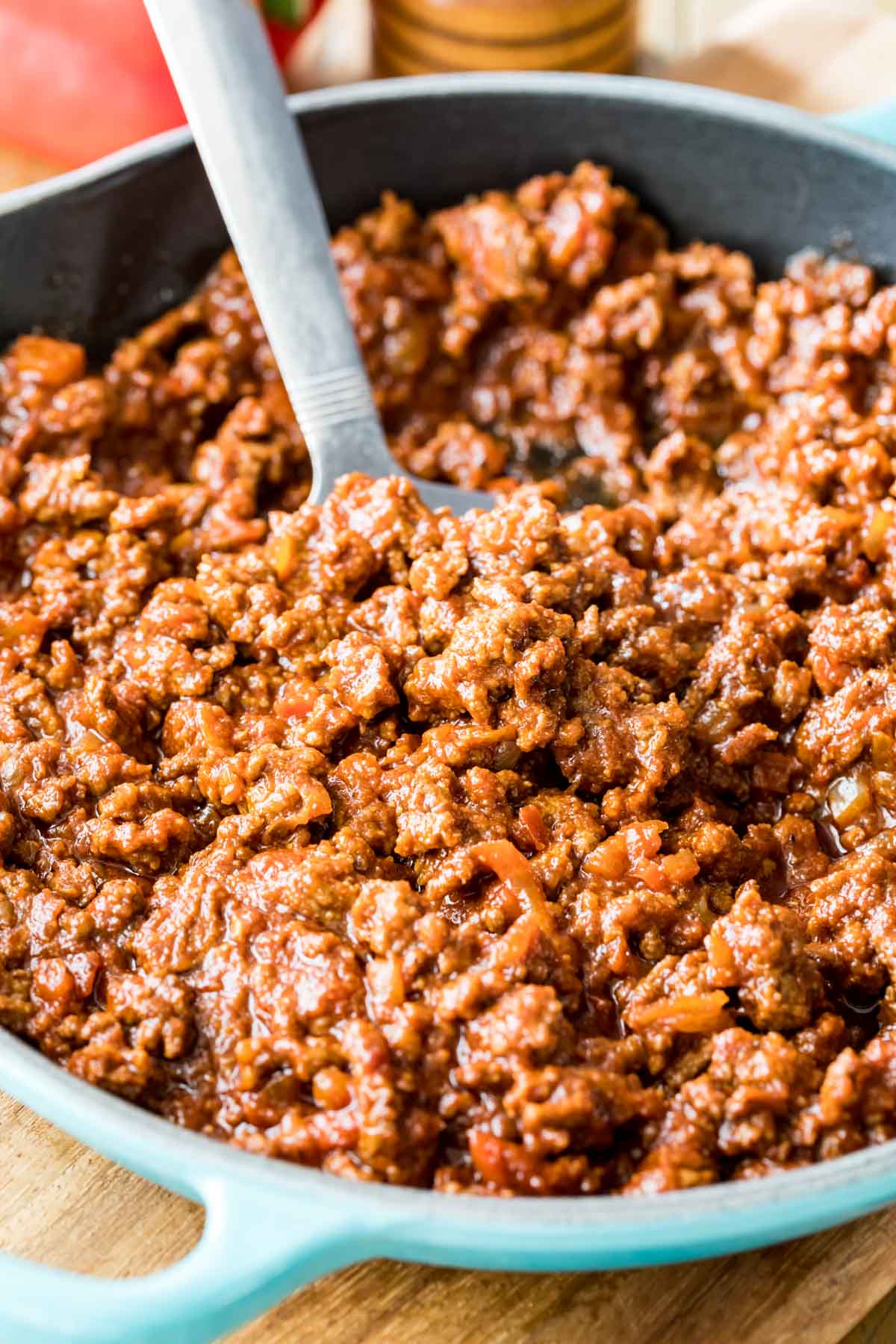 bright blue skillet with a saucy ground beef mixture inside