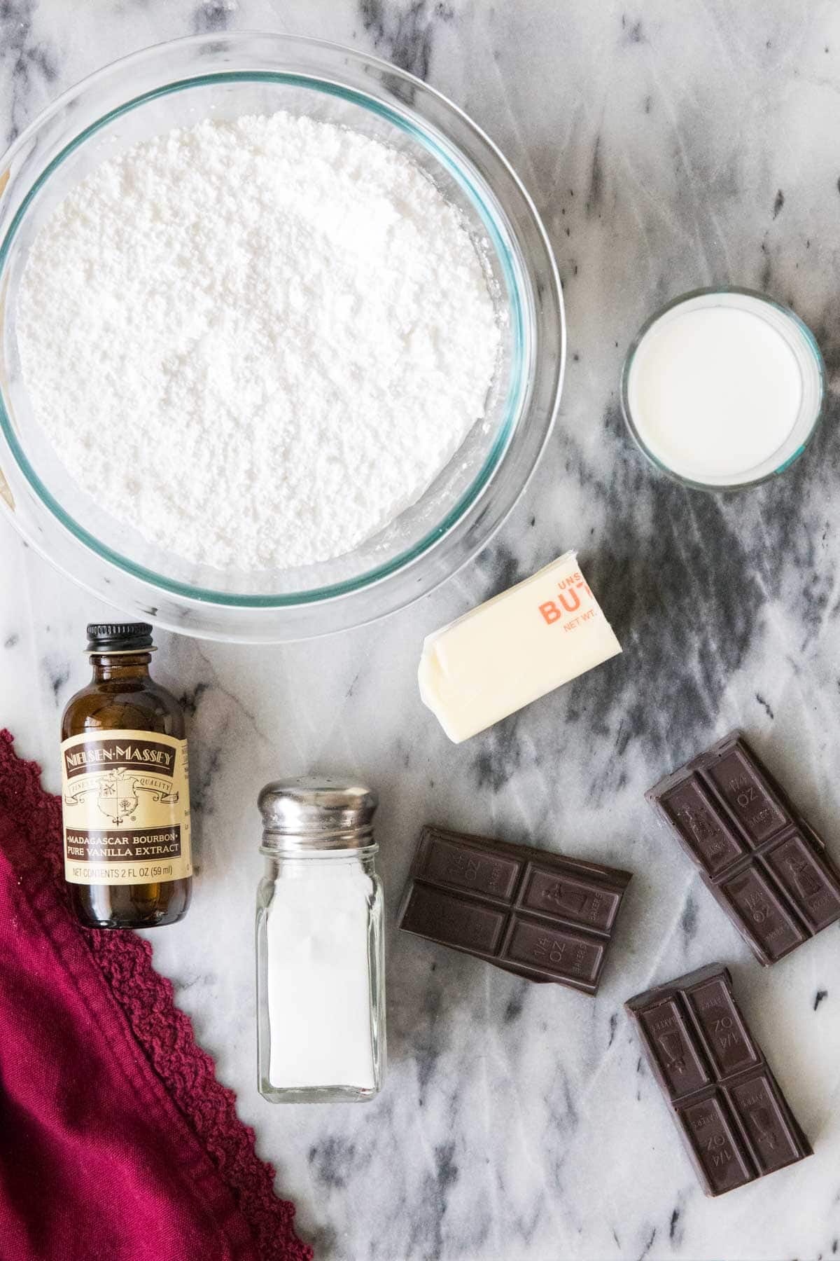 overhead view of ingredients including powdered sugar, vanilla, chocolate bars, and more