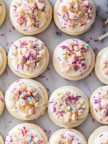 overhead view of frosted birthday cake cookies in neat rows
