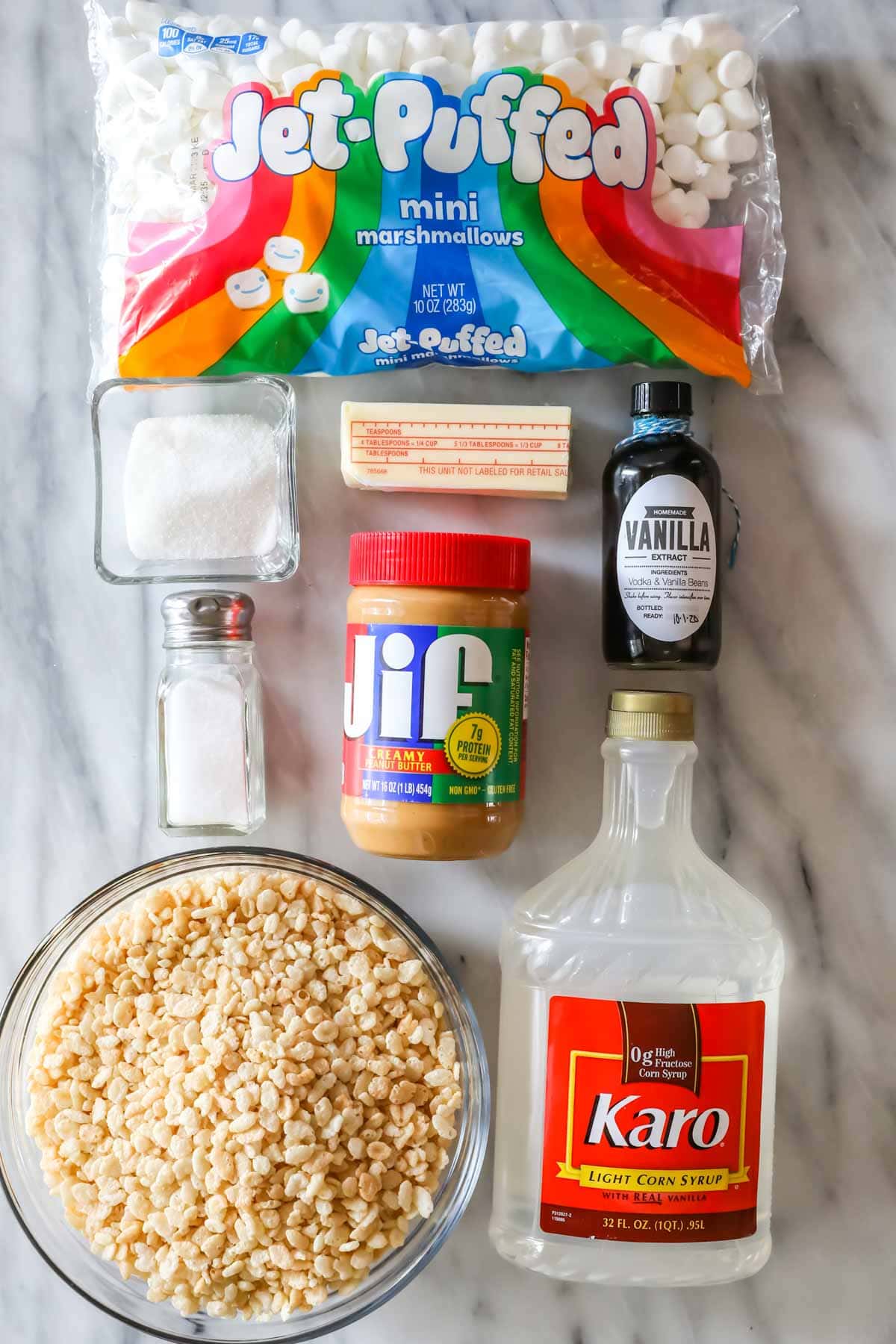 Overhead view of ingredients including marshmallows, peanut butter, rice krispies cereal, and more.