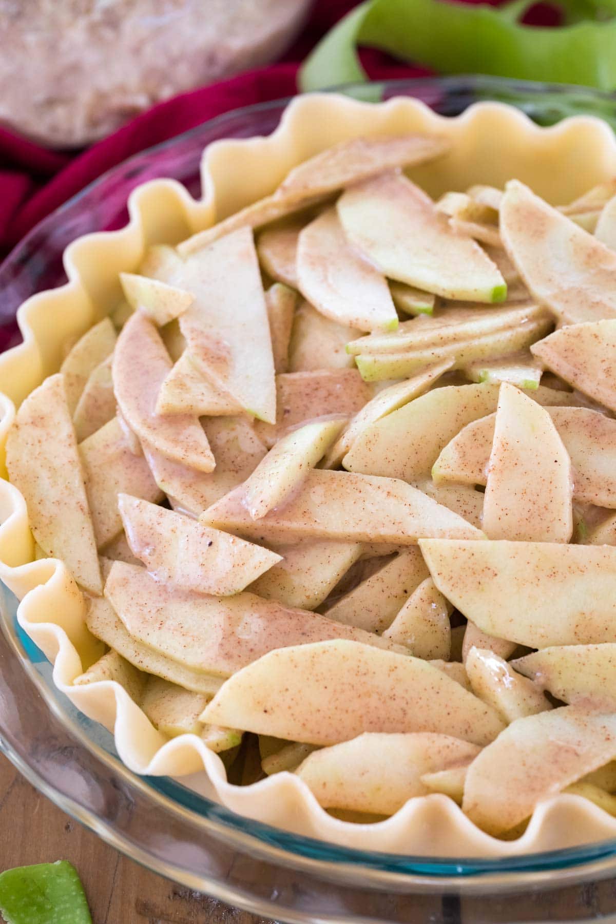 Pie shell filled with apple slices before baking.