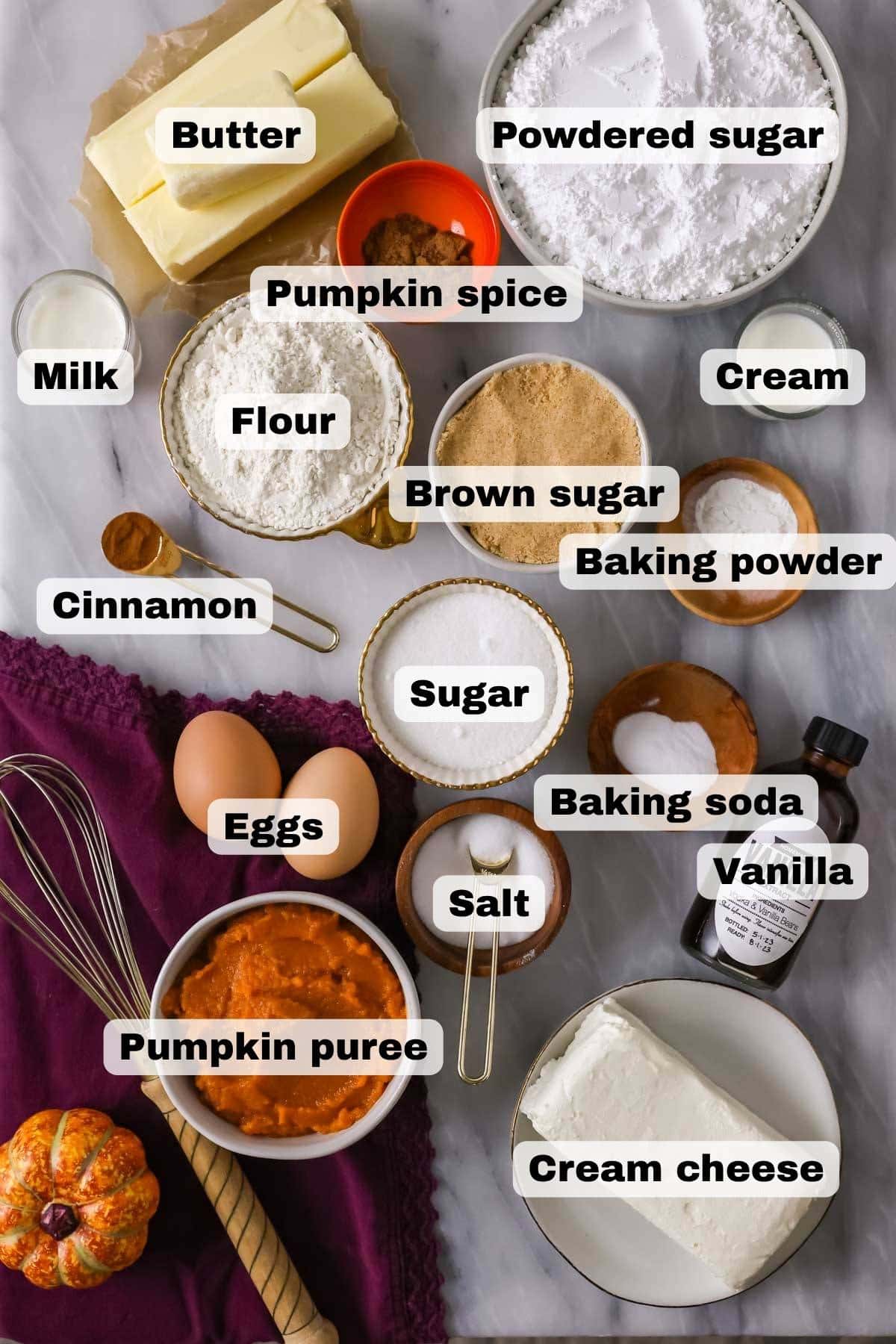 Overhead view of ingredients including pumpkin, spices, butter, and more.
