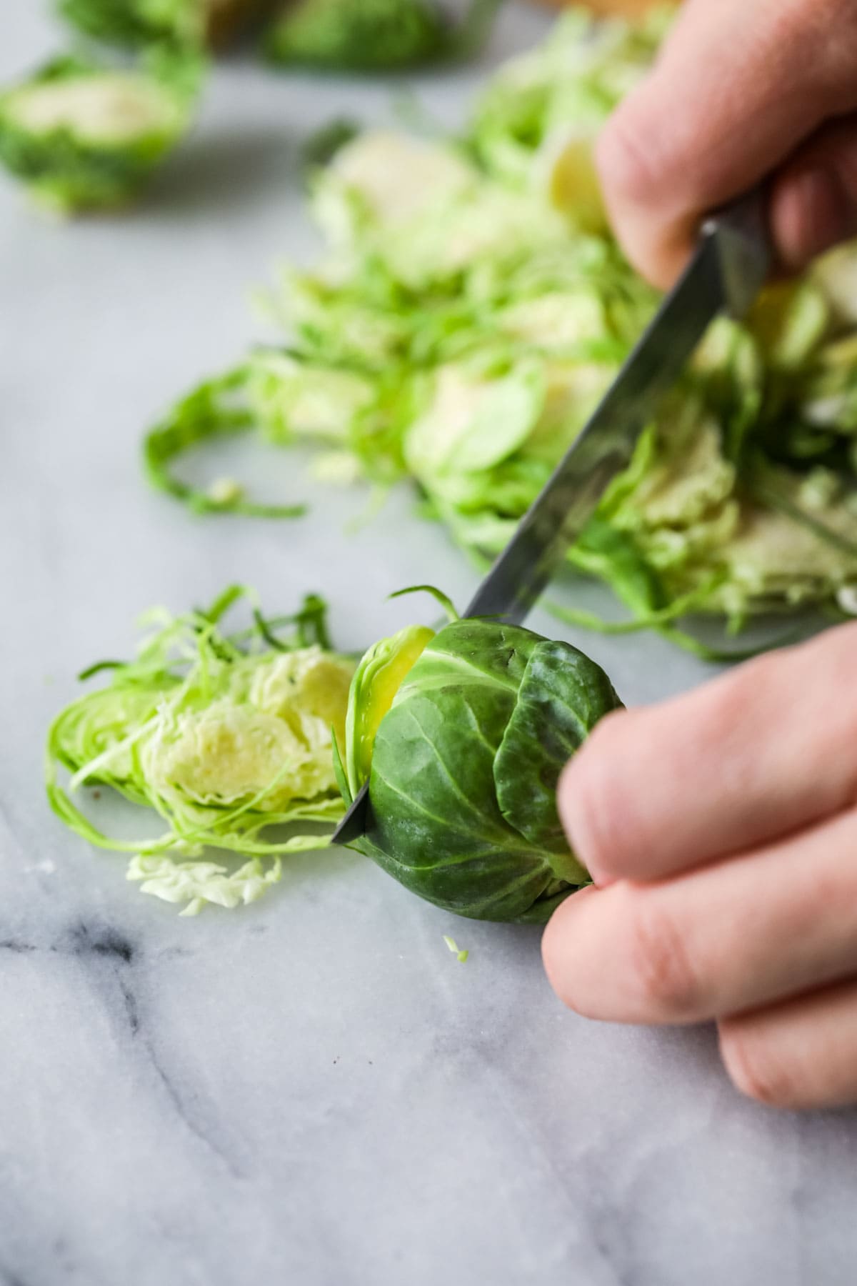 thinly slicing brussel sprout to shave it