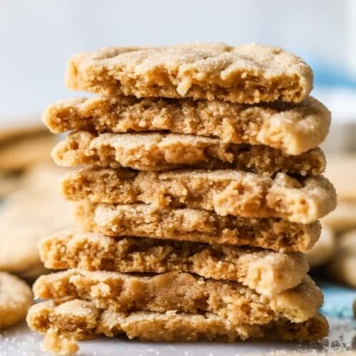 Stack of peanut butter crinkle cookies halved to shown their texture.
