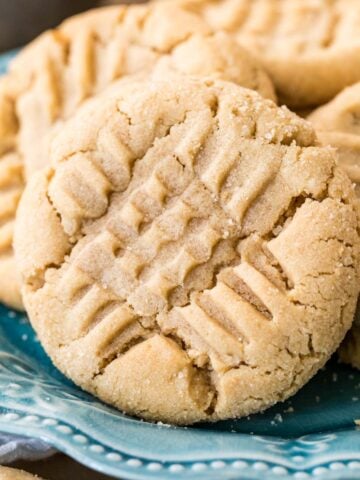 Peanut butter cookies with a criss cross fork design on top.
