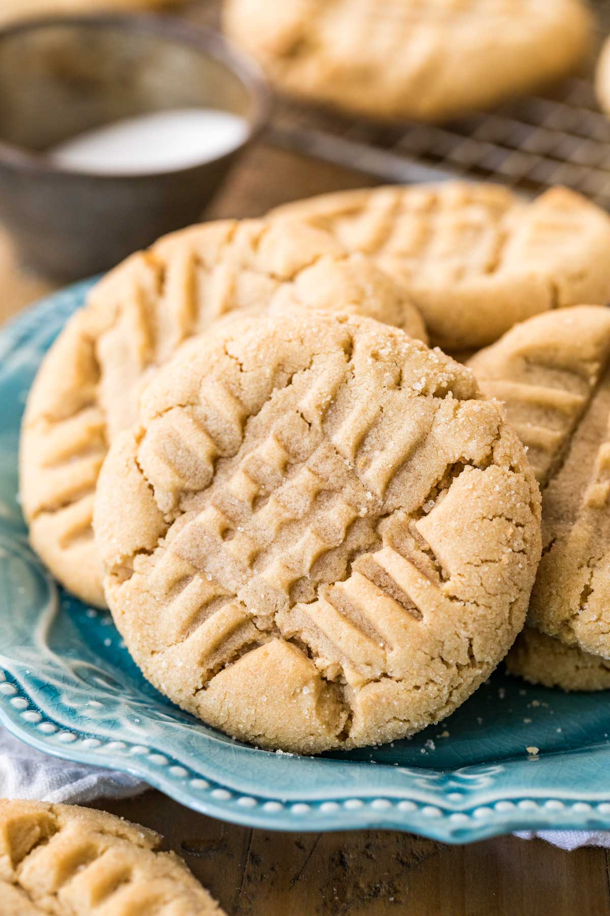 Peanut butter cookies with a criss cross fork design on top.