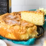 Slices being cut and served from an olive oil cake.