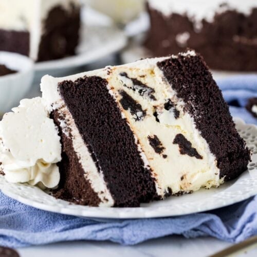 Slice of Oreo cheesecake cake on a plate.