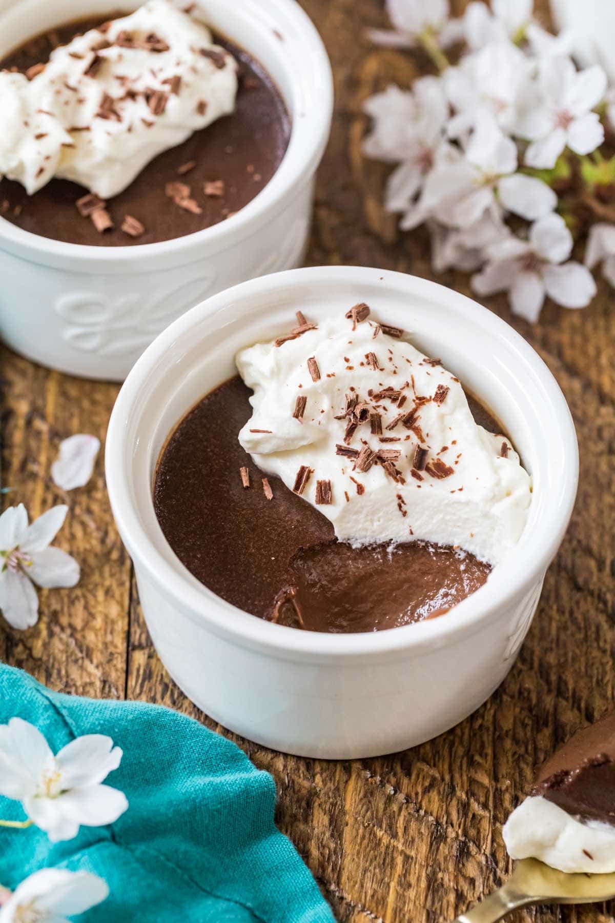 Overhead view of a ramekin of pot de creme with several spoonfuls missing.