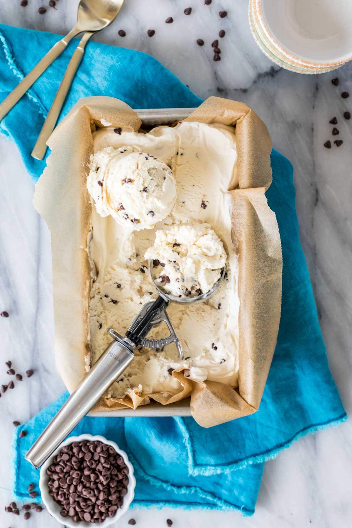 Overhead view of a parchment lined pan of chocolate chip cookie dough ice cream.