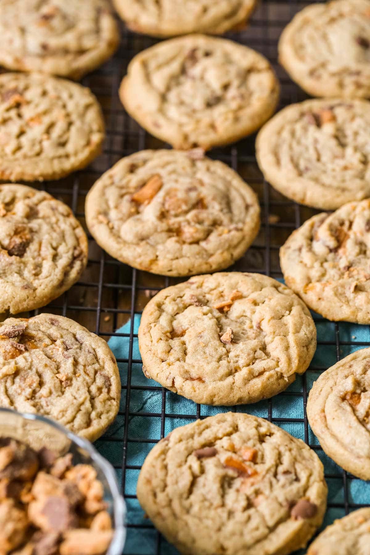 Cooling rack of cookies made with crushed butterfinger candies.