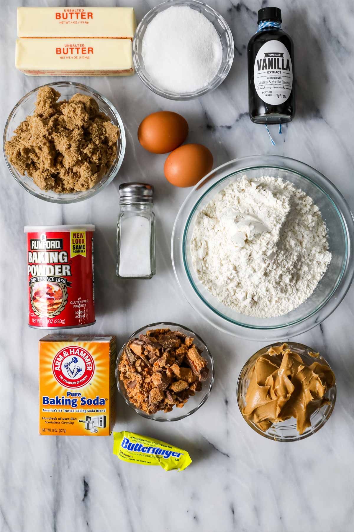 Overhead view of ingredients including butterfinger candies, peanut butter, brown sugar, and more.