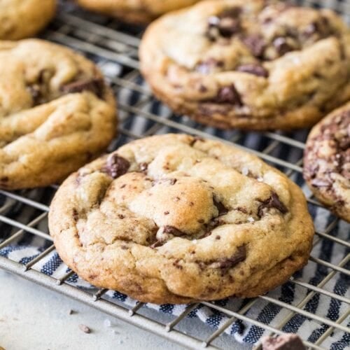 Brown butter chocolate chip cookies on a metal cooling rack.