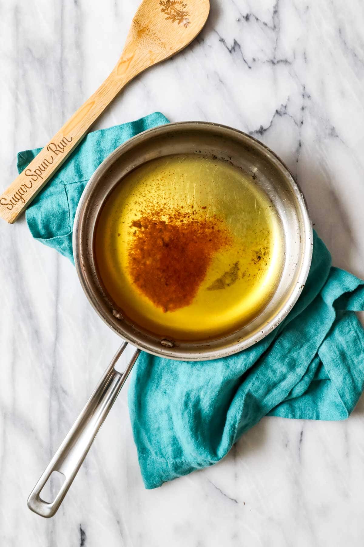 Overhead view of browned butter in a saucepan.