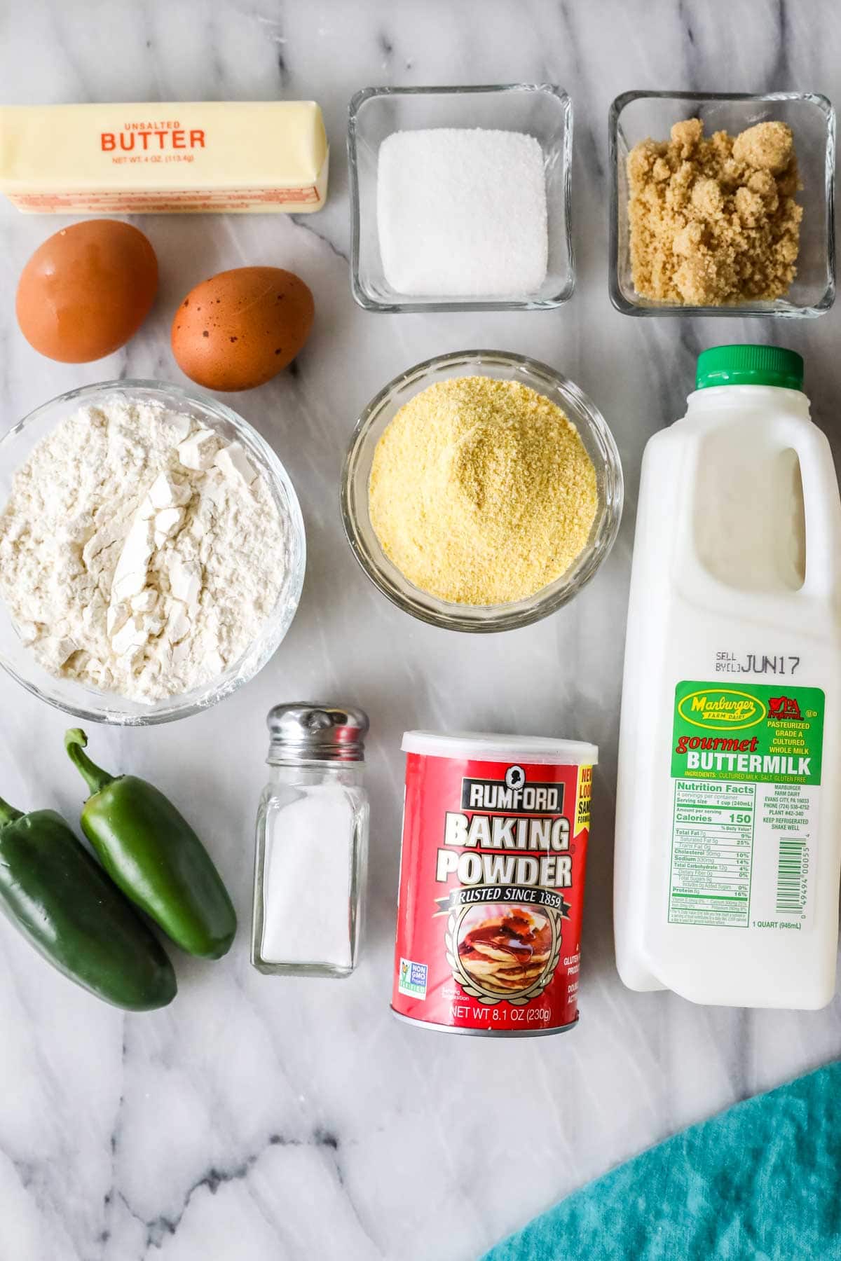 Overhead view of ingredients including cornmeal, buttermilk, jalapenos, and more.