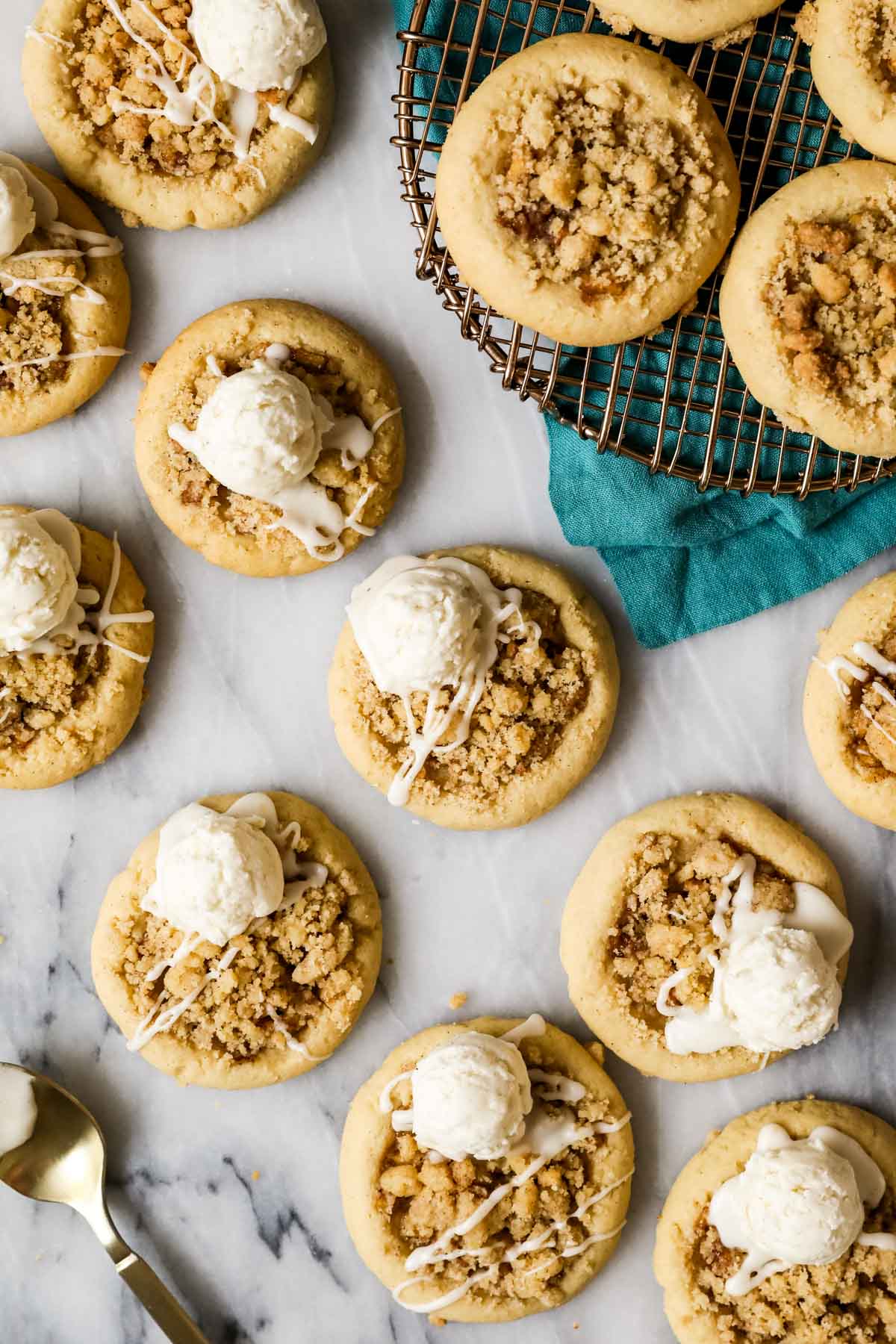 Overhead view of apple pie cookies topped with a glaze and scoop of buttercream "ice cream".