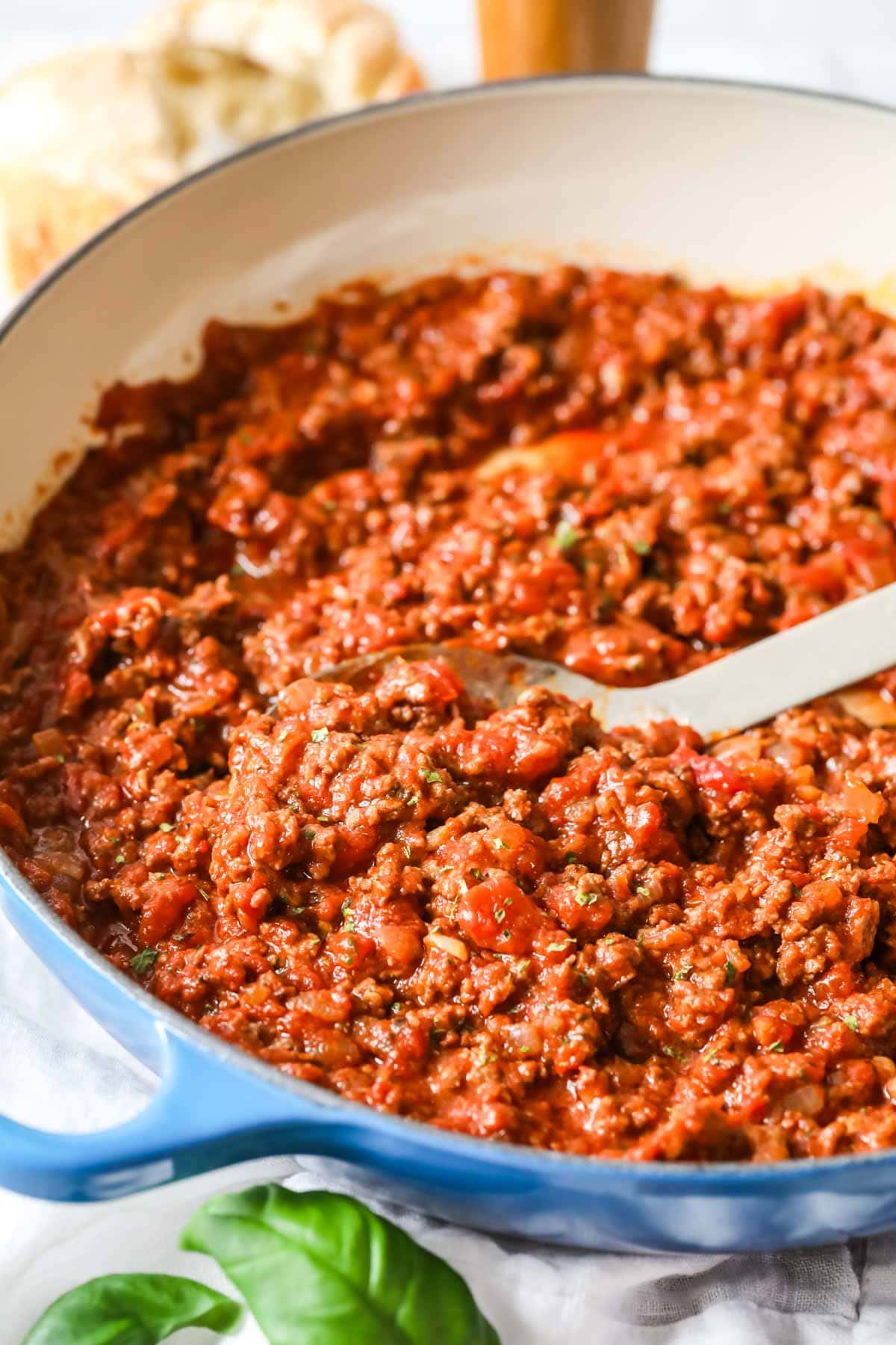 Close up view of a cast iron pan of meat sauce.