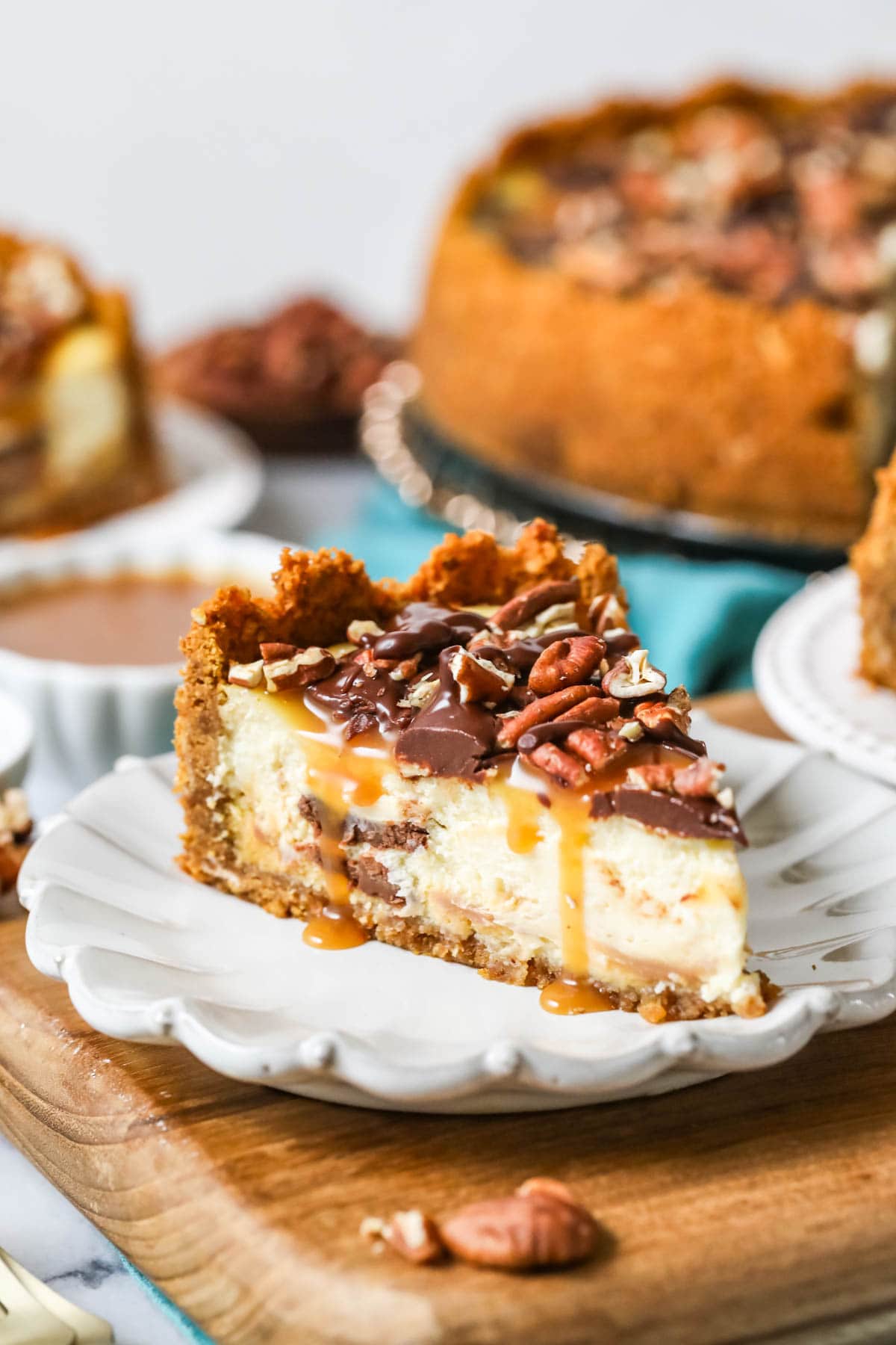 Slice of turtle cheesecake on a plate.