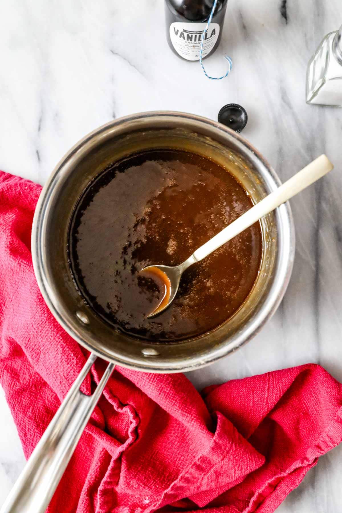 Overhead view of a brown sugar syrup in a saucepan.