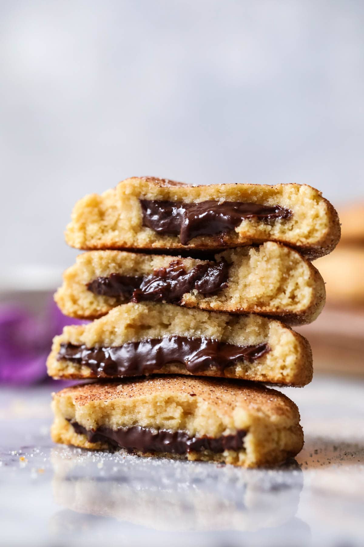 Two churro cookies that have been cut in half and stacked on top of each other in a tower.