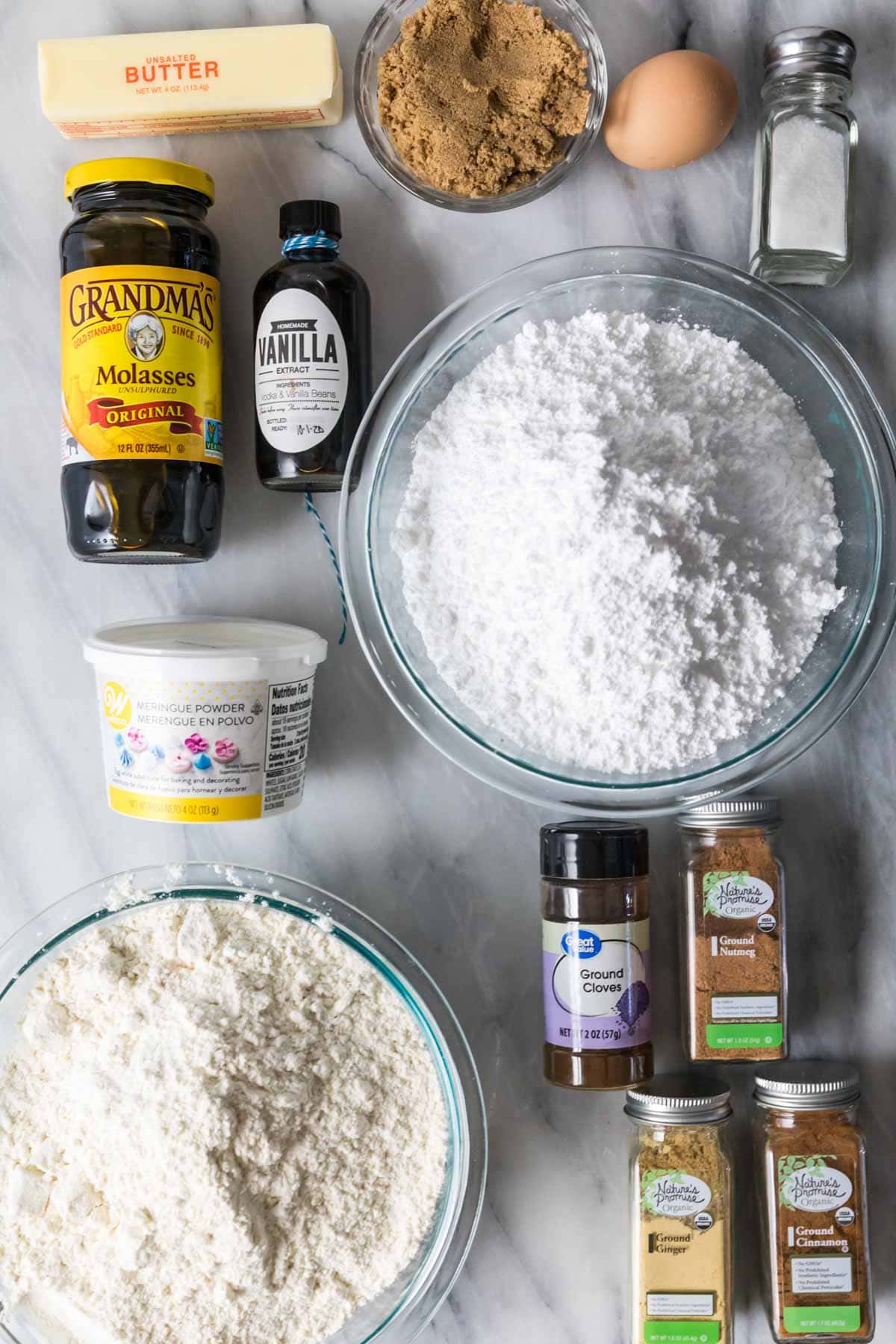 Overhead view of ingredients including molasses, spices, meringue powder, and more.