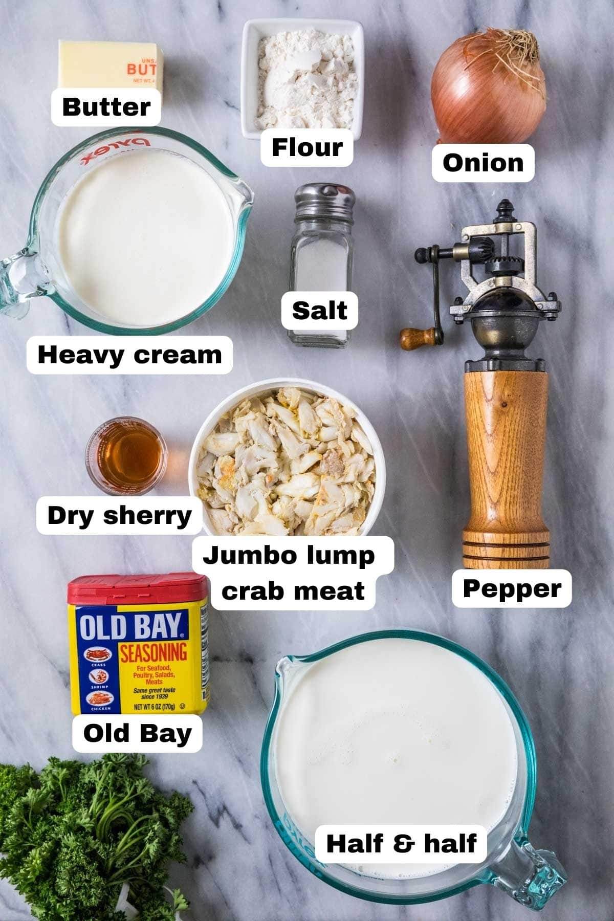 Overhead view of labelled ingredients including cream, crab meat, old bay, and more.